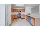 Kitchen with wood cabinets and teal appliances at 33868 N Mercedes Dr, San Tan Valley, AZ 85144