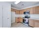 Modern kitchen with wood cabinets and teal appliances at 33868 N Mercedes Dr, San Tan Valley, AZ 85144