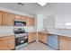 Modern kitchen featuring wood cabinets and teal appliances at 33868 N Mercedes Dr, San Tan Valley, AZ 85144