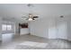 Spacious living room featuring light walls, ceiling fan, and laminate flooring at 33868 N Mercedes Dr, San Tan Valley, AZ 85144