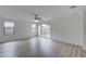 Living room with sliding glass doors, laminate flooring, and neutral walls at 33868 N Mercedes Dr, San Tan Valley, AZ 85144