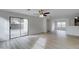 Bright living room with sliding glass doors and laminate wood flooring at 33868 N Mercedes Dr, San Tan Valley, AZ 85144