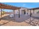 Nice backyard with pergola, patio, and gravel at 36148 W Seville Dr, Maricopa, AZ 85138