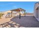 Relaxing backyard with pergola and gravel landscaping at 36148 W Seville Dr, Maricopa, AZ 85138