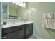 Bathroom with double vanity and large mirror at 36148 W Seville Dr, Maricopa, AZ 85138