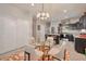 Bright dining area with glass table and modern chandelier at 36148 W Seville Dr, Maricopa, AZ 85138