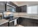 Modern kitchen featuring stainless steel appliances and granite countertops at 36148 W Seville Dr, Maricopa, AZ 85138