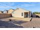 Large backyard with covered patio, fire pit, and gravel landscaping at 36509 W Nina St, Maricopa, AZ 85138