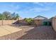 Backyard with gravel, fire pit, and small palm tree at 36509 W Nina St, Maricopa, AZ 85138