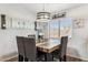 Dining area with a rustic wooden table and gray cushioned chairs at 36509 W Nina St, Maricopa, AZ 85138