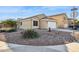 House exterior showcasing a landscaped front yard and a two-car garage at 36509 W Nina St, Maricopa, AZ 85138