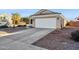 House exterior with a two-car garage and well-maintained landscaping at 36509 W Nina St, Maricopa, AZ 85138