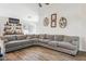 Living area featuring a sectional sofa and built-in shelving at 36509 W Nina St, Maricopa, AZ 85138