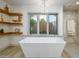 Spa-like bathroom with a freestanding tub and modern shelving at 3921 E San Miguel Ave, Paradise Valley, AZ 85253