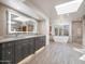 Modern bathroom with double sinks, a large soaking tub, and skylights at 3921 E San Miguel Ave, Paradise Valley, AZ 85253