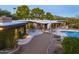 Luxury pool and patio area with mountain views at dusk at 3921 E San Miguel Ave, Paradise Valley, AZ 85253