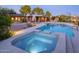 Relaxing backyard oasis featuring a sparkling pool, hot tub, and ample patio space at 3921 E San Miguel Ave, Paradise Valley, AZ 85253