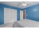 Bedroom with double door closet and ceiling fan at 403 S 228Th Ln, Buckeye, AZ 85326