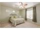 Relaxing bedroom with ceiling fan, neutral walls and carpeting at 403 S 228Th Ln, Buckeye, AZ 85326