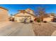 Two-story house with tan exterior, two-car garage, and small front yard at 403 S 228Th Ln, Buckeye, AZ 85326