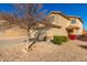 Two-story house with a tree, desert landscaping and attached garage at 403 S 228Th Ln, Buckeye, AZ 85326