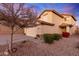 Two-story house with desert landscaping, two-car garage, and neutral color scheme at 403 S 228Th Ln, Buckeye, AZ 85326