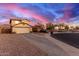 Two-story house with tan exterior, two-car garage, and desert landscaping at 403 S 228Th Ln, Buckeye, AZ 85326