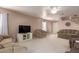 Spacious living room with neutral colors, comfy seating, and a TV at 403 S 228Th Ln, Buckeye, AZ 85326