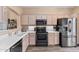 Kitchen with light wood cabinets, black appliances, and white counters at 4109 E Barwick Dr, Cave Creek, AZ 85331