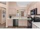 Kitchen boasts light wood cabinets and black appliances at 4109 E Barwick Dr, Cave Creek, AZ 85331