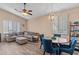 Open living and dining area with gray sectional sofa and blue chairs at 4109 E Barwick Dr, Cave Creek, AZ 85331