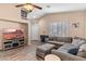 Living room with sectional sofa, TV, and wood-look floors at 4109 E Barwick Dr, Cave Creek, AZ 85331