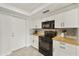 Modern kitchen with wood countertops and black appliances at 4149 W Park Ave, Chandler, AZ 85226