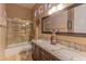 Shared bathroom with double sinks and a tub shower combo at 4410 E Robin Ln, Phoenix, AZ 85050