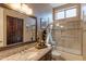 Bathroom with granite vanity, large mirror, and a shower/tub combo at 4410 E Robin Ln, Phoenix, AZ 85050