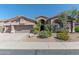 Beautiful desert landscaping surrounds this single-story home with a 3-car garage at 4410 E Robin Ln, Phoenix, AZ 85050