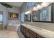 Elegant main bathroom with granite countertops and a soaking tub at 4410 E Robin Ln, Phoenix, AZ 85050