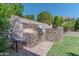 Built-in outdoor kitchen with stone accents and grill at 4410 E Robin Ln, Phoenix, AZ 85050