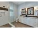 Bathroom with double vanity, frameless shower, and dark wood flooring at 4643 E Montecito Ave, Phoenix, AZ 85018