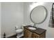 Stylish powder room with unique vanity and mirror at 4643 E Montecito Ave, Phoenix, AZ 85018