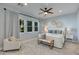 Spacious bedroom with light blue walls, carpeted floors, and ceiling fan at 4643 E Montecito Ave, Phoenix, AZ 85018