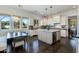 Modern kitchen with white cabinets, granite island, and breakfast nook at 4643 E Montecito Ave, Phoenix, AZ 85018