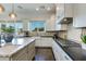 Modern kitchen with white cabinets, granite countertops, and gas range at 4643 E Montecito Ave, Phoenix, AZ 85018