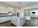 Modern kitchen with white cabinets, granite island, and open concept design at 4643 E Montecito Ave, Phoenix, AZ 85018