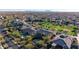 Scenic aerial view of a vibrant neighborhood featuring well-manicured lawns, tree-lined streets, and community green spaces at 4813 S Quantum Way, Mesa, AZ 85212