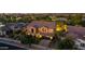 Aerial view of a lovely home with a tile roof surrounded by mature trees in a well-lit neighborhood at 4813 S Quantum Way, Mesa, AZ 85212