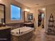 Luxurious bathroom with a soaking tub and walk-in closet at 4813 S Quantum Way, Mesa, AZ 85212