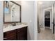 Well-lit bathroom with a dark wood vanity, neutral walls and mosaic tile at 4813 S Quantum Way, Mesa, AZ 85212