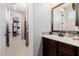 Bathroom features a dark vanity with a framed mirror and tiled backsplash at 4813 S Quantum Way, Mesa, AZ 85212