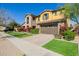 Two-story home featuring a stone and stucco exterior, a well-manicured lawn and a two car garage at 4813 S Quantum Way, Mesa, AZ 85212